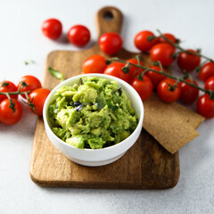 Homemade avocado dip with ripe tomatoes