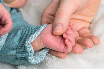 sweet tiny new born baby hand hold mum index finger. concept relationship between mother or parants and baby - 619715899