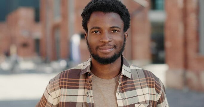 Portrait of a Black cheerful hipster pleasantly looking at camera.