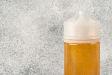 Refill liquid for electronic cigarettes on gray background