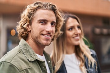 Man and woman couple smiling confident standing together at street