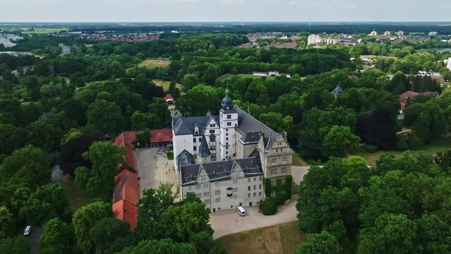 Drone shot of Wolfsburg Castle ( Schloss Wolfsburg ) . The Wolfsburg is a medieval lowland and water castle in North Germany .