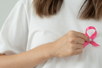 Woman hold pink ribbon breast cancer awareness. Female health check consciousness. international...