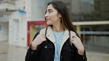 Young beautiful hispanic woman student smiling confident standing at street