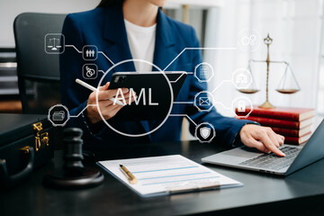 AML Anti Money Laundering Financial Bank Business Concept. judge in a courtroom using laptop and tablet with AML anti money laundering icon on virtual  screen. .