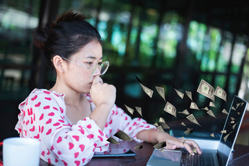 Successful young beautiful southeast asian woman using laptop create online business make money...