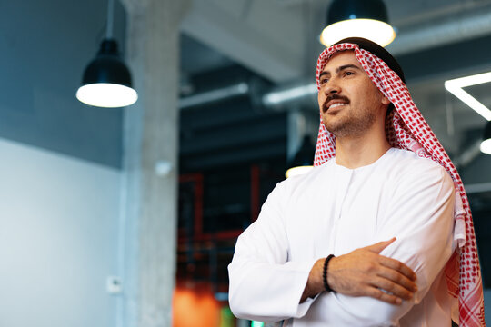 Successful muslim businessmen in traditional outfit in his office