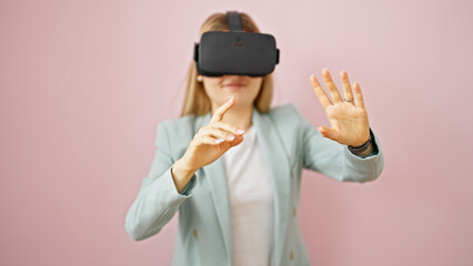 Young blonde woman business worker using virtual reality glasses over isolated pink background