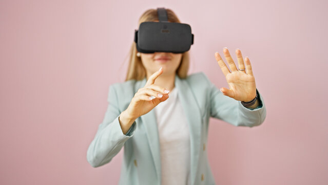 Young blonde woman business worker using virtual reality glasses over isolated pink background