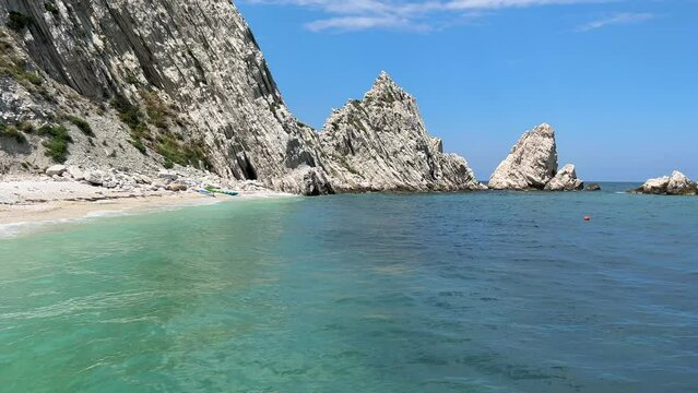 Beach of the two sisters of Sirolo with emerald water in the Marche region during summer season Italy