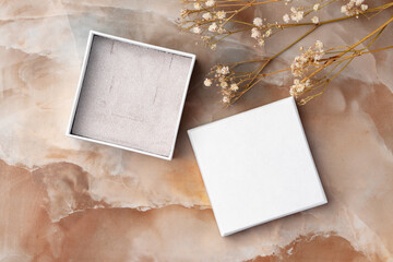 White jewelry box on a white marble background