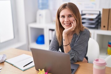 Young blonde woman business worker using laptop working at office