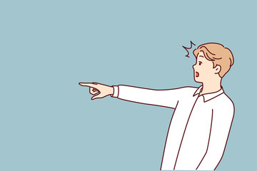 Surprised man with WOW emotions points finger to side, draw customer attention to copy space. Surprised guy attract interest of potential customers to advertised goods and services.