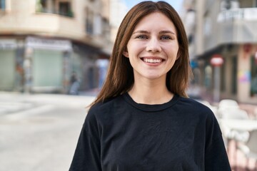 Young blonde woman smiling confident standing at street