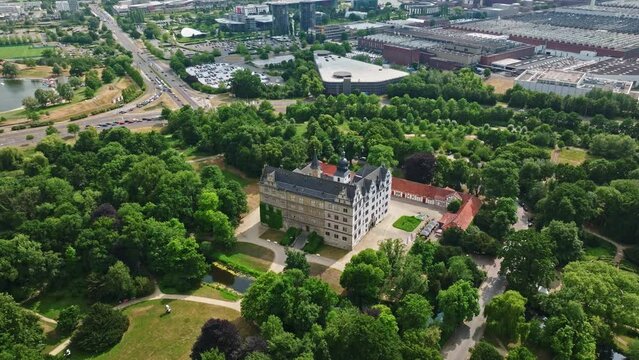 Drone shot of Wolfsburg Castle ( Schloss Wolfsburg ) . The Wolfsburg is a medieval lowland and water castle in North Germany .