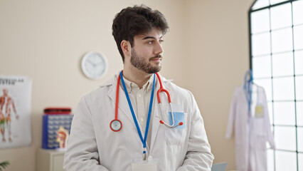Young hispanic man doctor wearing stethoscope at clinic
