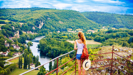 Woman tourist enjoying beautiful panoramic view of valley of Lot river in France, Occitanie © M.studio