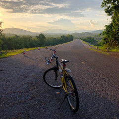 Fototapeta na wymiar Bike at sunset,mountain,blue sky. Din Dam Thapha, Sirikit Dam uttaradit Thailand.Bike at sunset,mountain,blue sky. Din Dam Thapha, Sirikit Dam uttaradit Thailand.