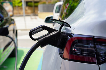 electric car charging in gas station. Renewable, sustainability and green energy. Climate change