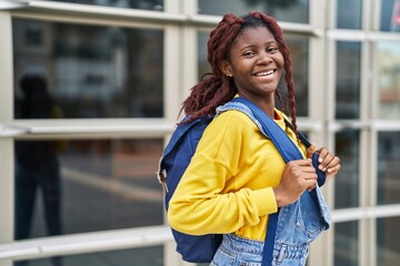 African american woman student smiling confident wearing backpack at university