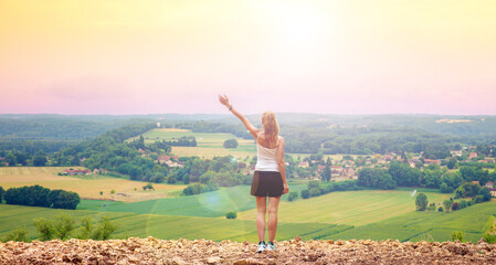 Woman standing in front of panoramic view of Dordogne landscape in France