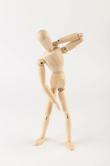 Wooden mannequin figure expressing neck pain.