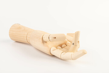 Wooden hand isolated on a white background. Copy space