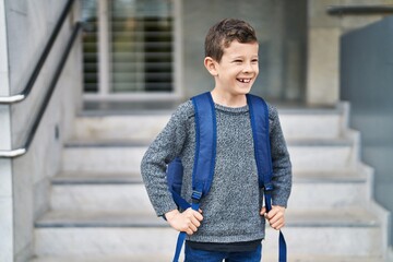 Blond child student smiling confident standing at school