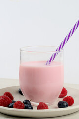 Glass of strawberry yogurt with red fruits