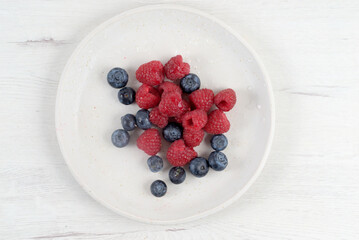 White plate with red fruit