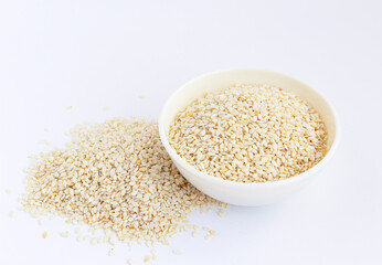 Sesame seeds in a white  bowl isolated on white. High angle.