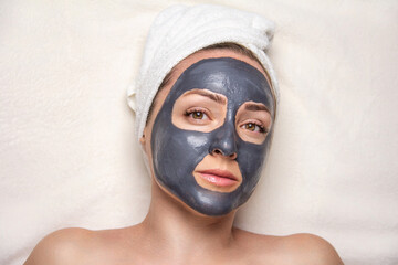 Portrait of a woman with a cleansing mask on her face.