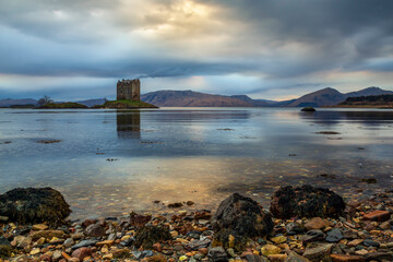 Twilight over Castle Stalker on the shores of Loch Laich in the Scottish Highlands