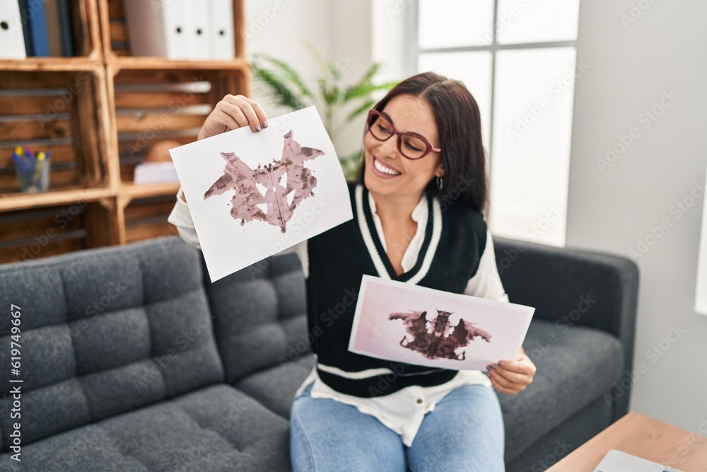 Canvas Prints Young beautiful hispanic woman psychologist having rorschach test at psychology clinic