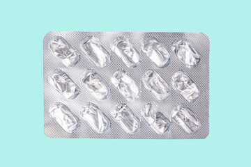 silver blister pack of antibiotic pills on a blue background