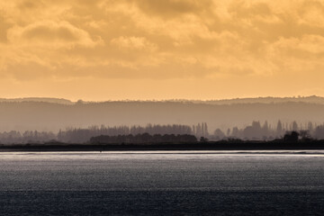 A photo looking across Pegwell Bay towards Sandwich at dusk