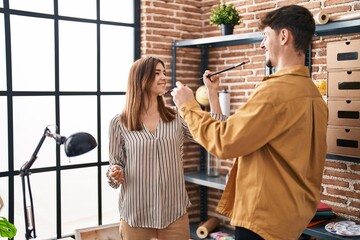 Mand and woman artist couple painting face playing at art studio