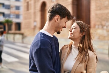 Mand and woman couple smiling confident standing together at street