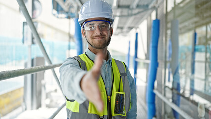Young caucasian man architect smiling confident shake hand at construction place