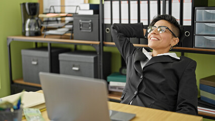 Young beautiful hispanic woman business worker smiling confident relaxing at office