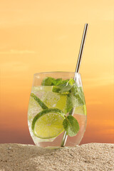 Mojito cocktail with citrus lime, lemon and orange on the beach