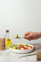 salad of fresh vegetables and greens with egg and feta cheese