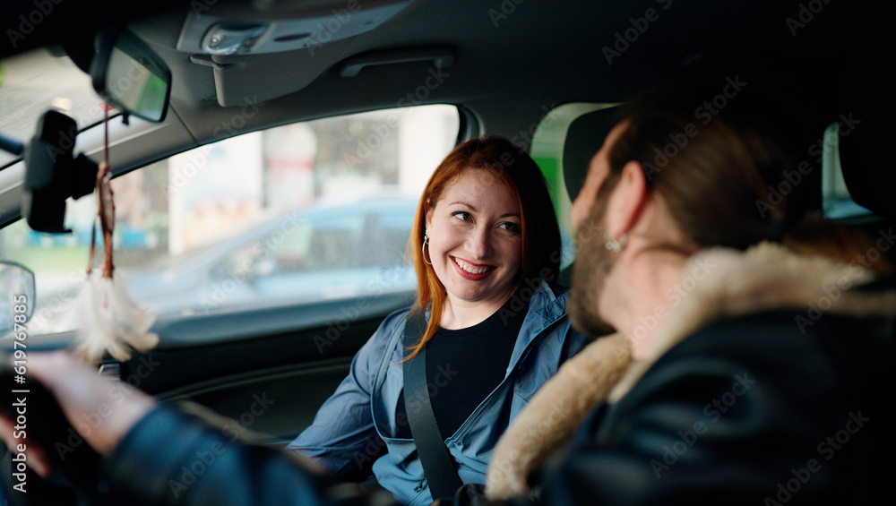 Poster Man and woman couple smiling confident driving car at street