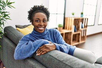 African american woman smiling confident sitting on sofa at home