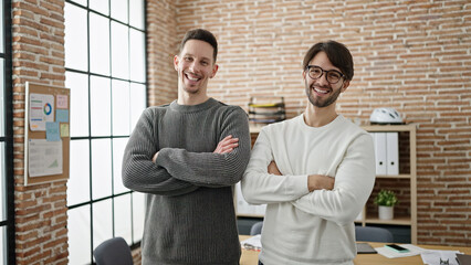 Two men business partners standing with arms crossed gesture at office