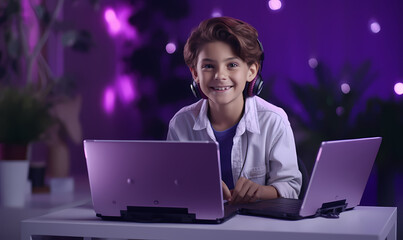 smiling boy using a laptop and wearing headphones