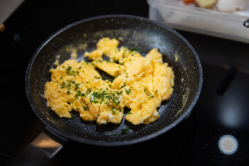 Scrambled eggs in cooking pan. Process of cooking scrambled eggs