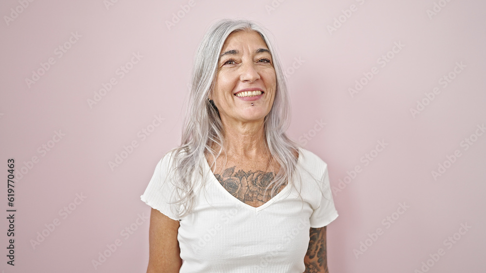 Canvas Prints Middle age grey-haired woman smiling confident standing over isolated pink background