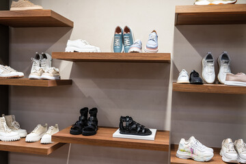 Shelf with different women's shoes in the store