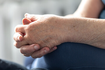 Close-up, the hands of an elderly woman.